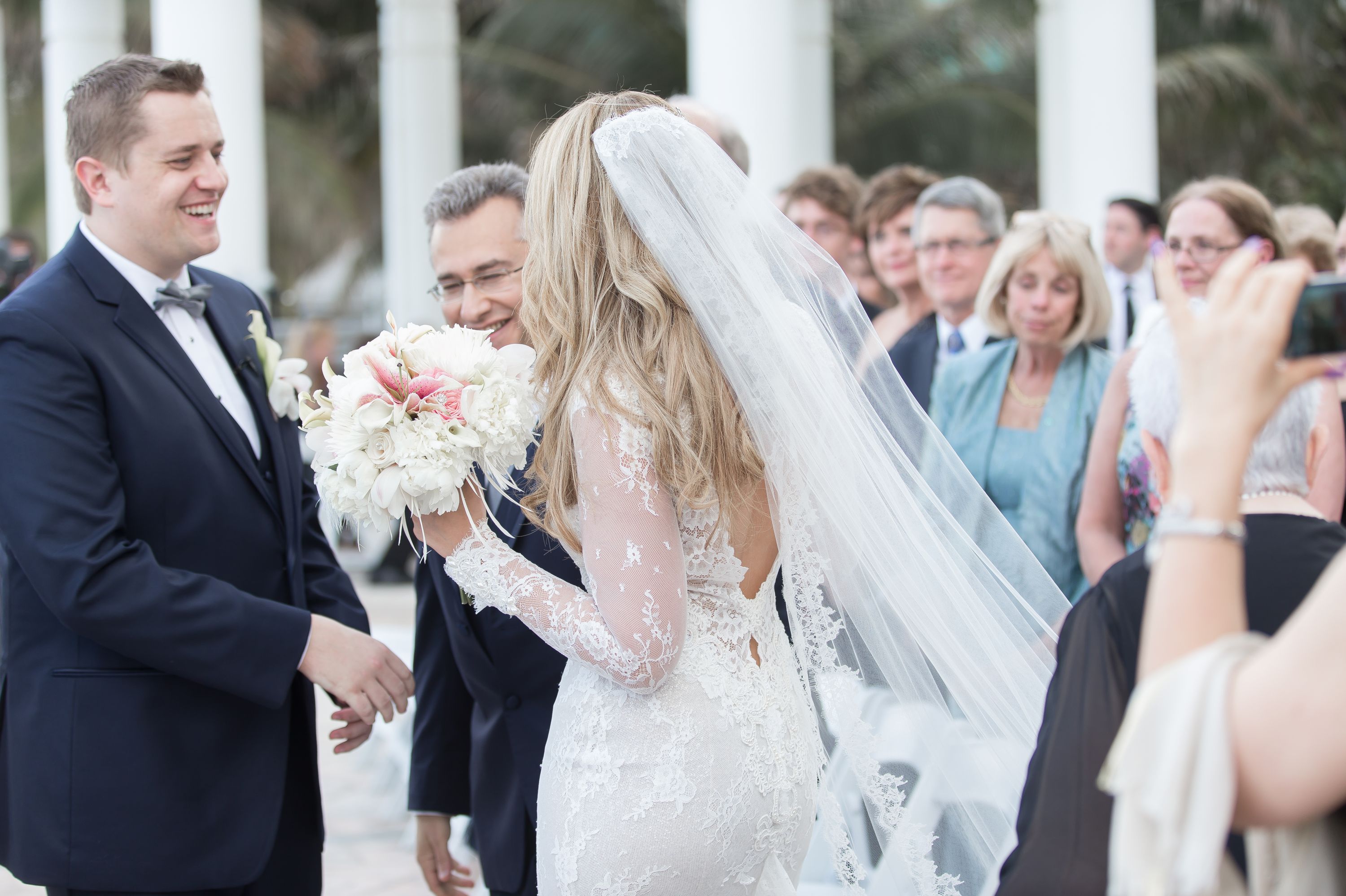 The pass off of the bride during this Diplomat Beach Resort Wedding