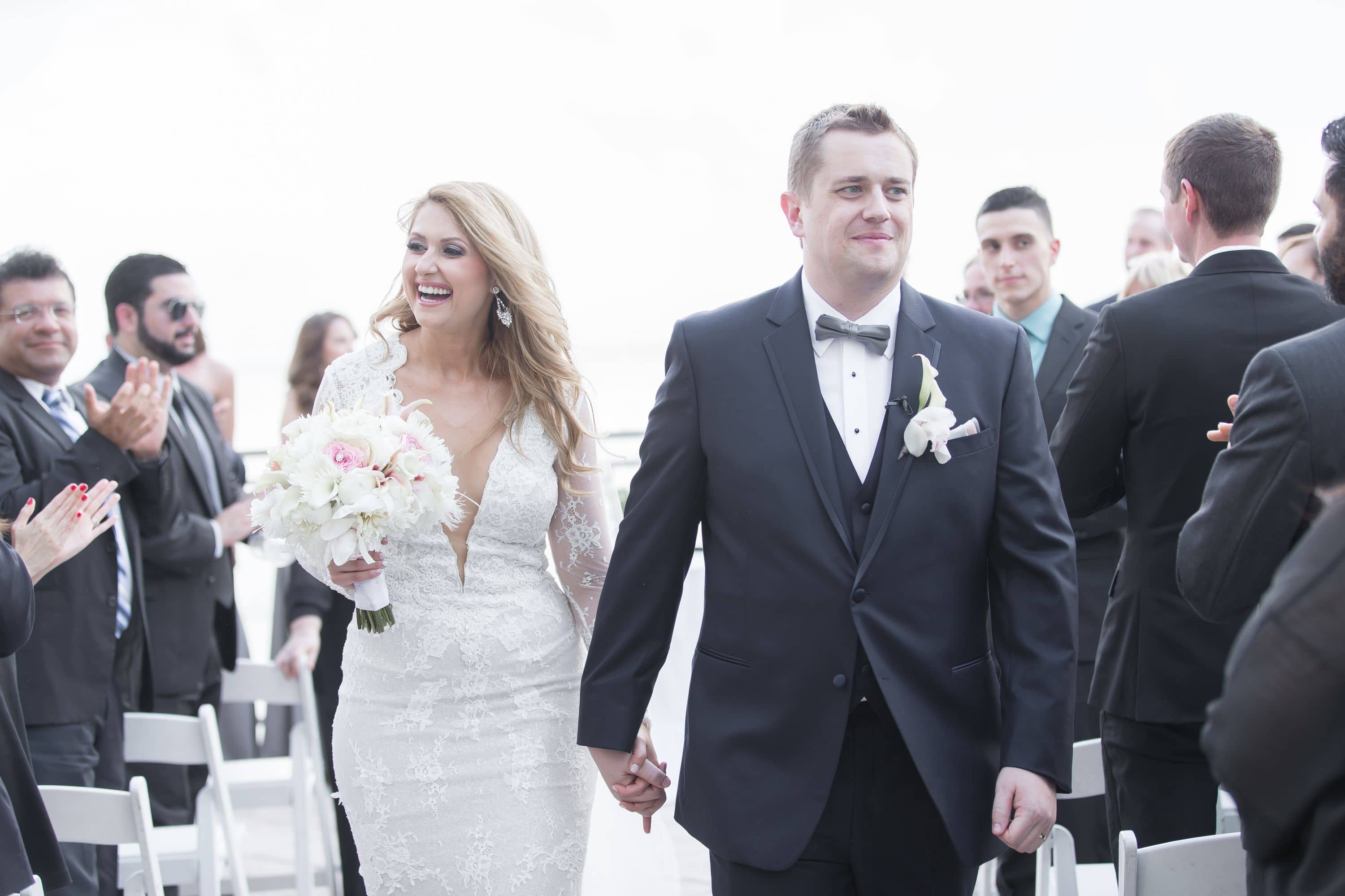 Moments after the ceremony the bride and groom walk back into this Diplomat Beach Resort Wedding