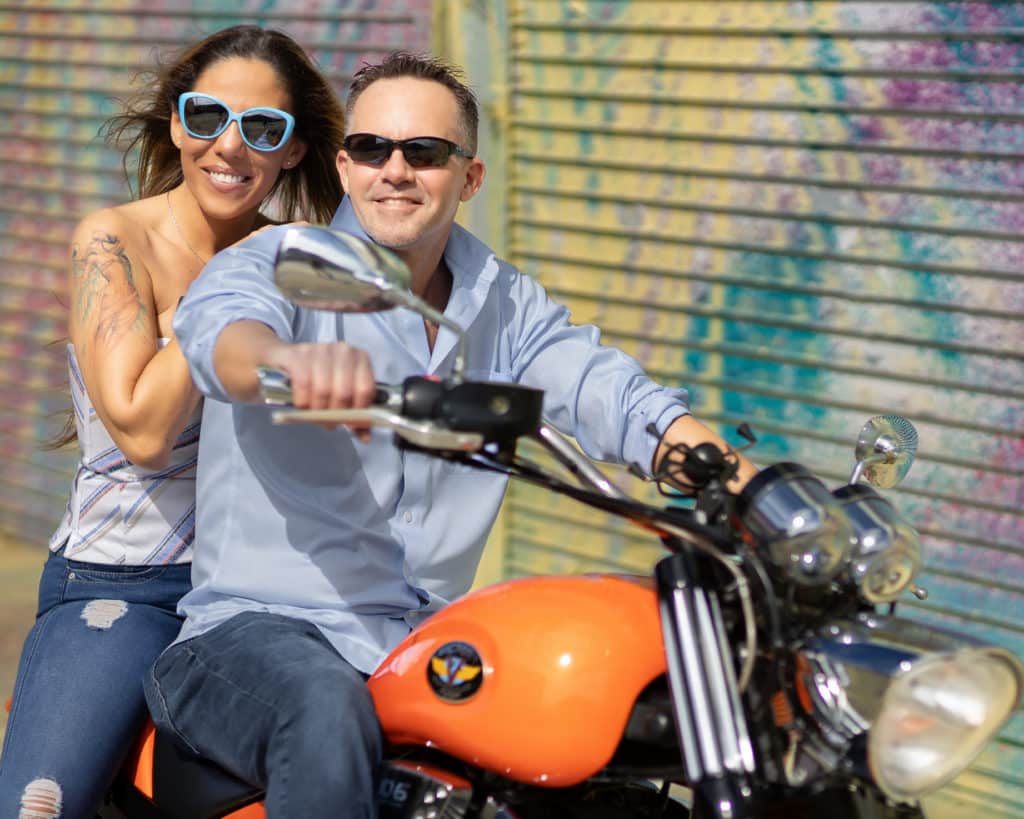 Bride and Groom on motorcycle for an engagement session in the Design District of Miami