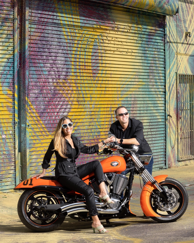 Bride and Groom posing with motorcycle on engagement session in Design District Miami